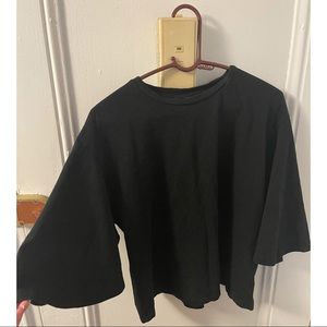 Black tee with large “bat” sleeves